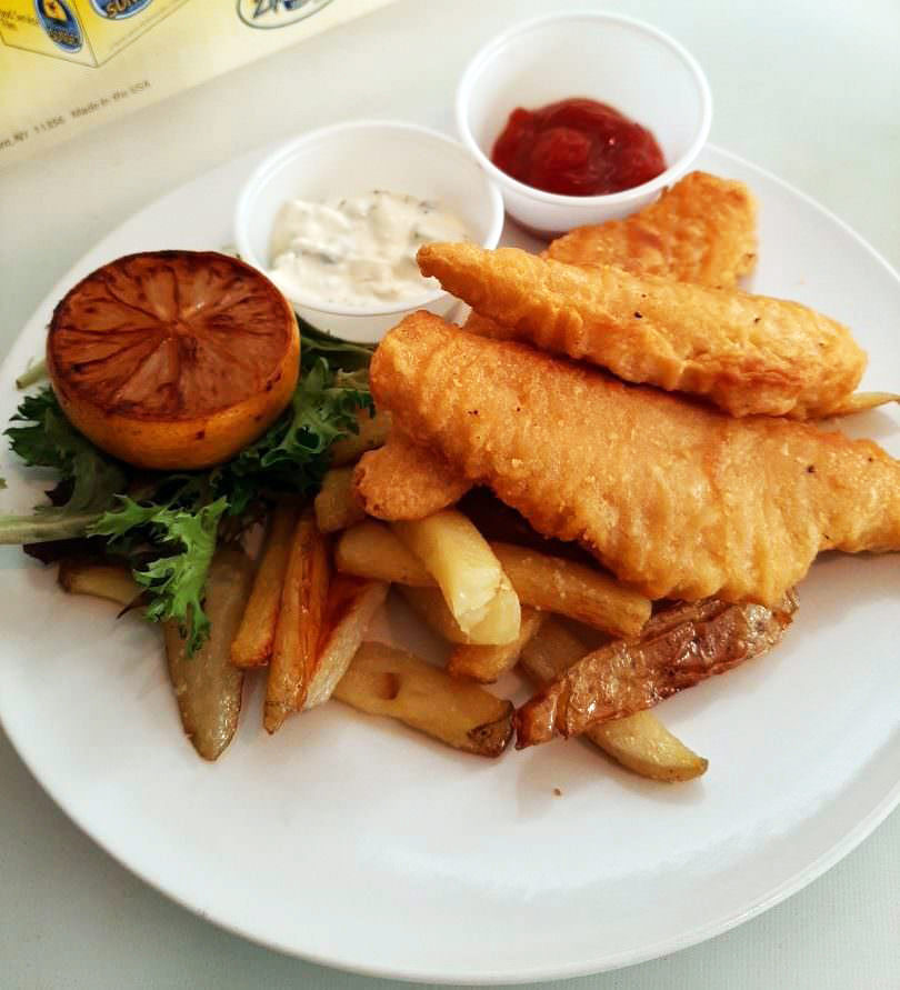 Beer-battered white fish and hand-cut fries with charred lemon, tartar sauce, and ketchup.